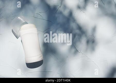 White deodorant bottle on textured concrete background with shadow with a copy space Stock Photo