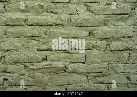 Background of old green brick wall with irregular texture. Stock Photo