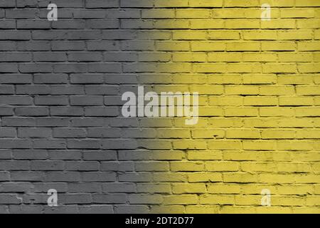 Ultimate Gray and Illuminating yellow brick wall toned in trendy colors of 2021. Brick wall background Stock Photo