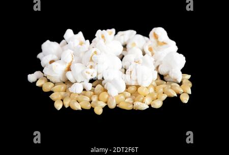 Popping corn and popped kernels on a black background Stock Photo