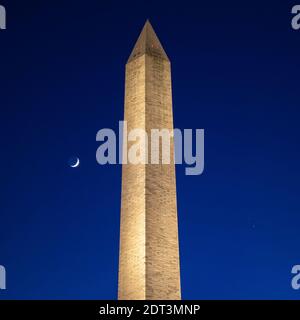 Washington, USA. 21st Dec, 2020. The Moon, left, Saturn, upper right, and Jupiter, lower right, are seen after sunset with the Washington Monument, Thurs. Dec. 17, 2020, in Washington. The two planets are drawing closer to each other in the sky as they head towards a “great conjunction” on December 21, where the two giant planets will appear a tenth of a degree apart. Photo Credit: (NASA/Bill Ingalls) Credit: Sipa USA/Alamy Live News Stock Photo