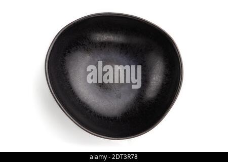 Empty black ceramic bowl isolated on white background. Top view, flat lay, close up. Stock Photo