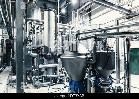 Modern brewery interior. Filtration vats, pipeline, valves and other equipment of beer production line. Stock Photo