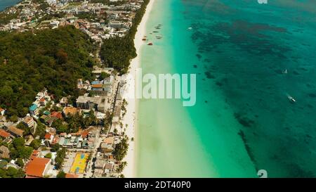 Aerial view of beautiful bay in tropical Island with white sand beach Boracay, Philippines. White beach with tourists and hotels. Tropical white beach with sailing boat. Stock Photo