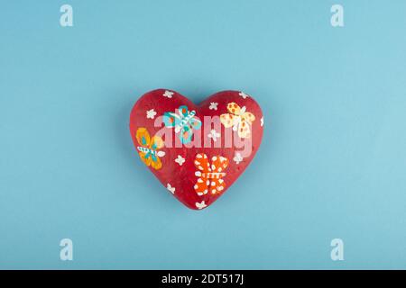 Colourful red heart isolated on light blue background. Stock Photo