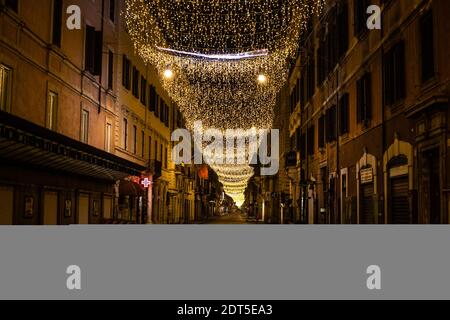 Rome, Italy. 20th Dec, 2020. View of Christmas decorations along Via del Corso Street in Rome.A curfew from 10pm to 5am was imposed by the Prime Minister's Decree to combat the Covid-19 surge. Credit: Cosimo Martemucci/SOPA Images/ZUMA Wire/Alamy Live News Stock Photo