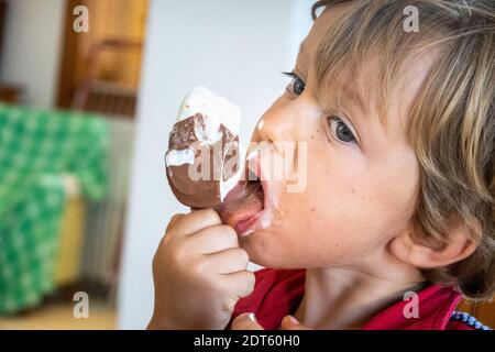 Close-up of boy eating chocolate ice cream Stock Photo