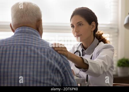 Supportive female doctor comfort senior male patient Stock Photo