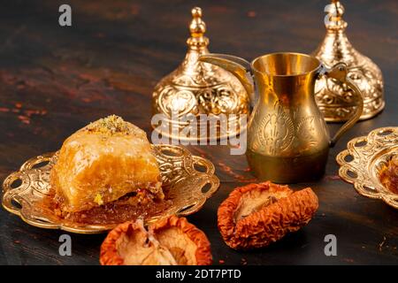 Piece of Turkish baklava in golden arabic plate Stock Photo