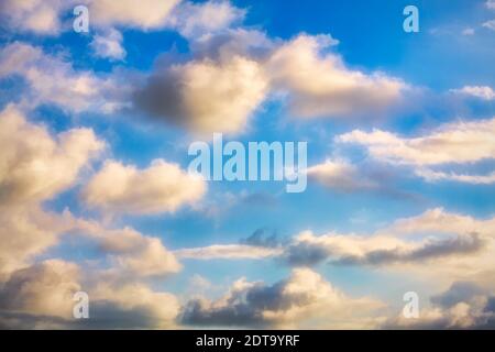 White Cumulus Clouds Are Set against a Bright Blue Daytime Sky Stock Photo