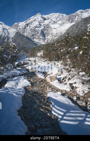 Sunny winter landscape in deep snow with mountain river in Austrian Alps, Mieming, Tyrol, Austria Stock Photo