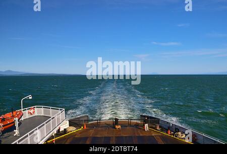 A view from the rear of a BC Ferry traveling from Vancouver to Vancouver Island on the west coast of British Columbia Canada. Stock Photo