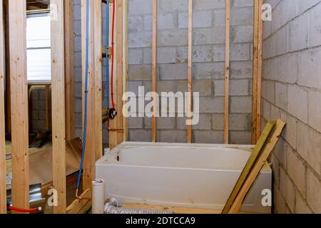 Bathroom showing plumbing work connecting installation of pipes with basement home under construction Stock Photo