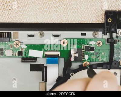 The master removes the cover on the computer with a screwdriver to repair computer equipment Stock Photo