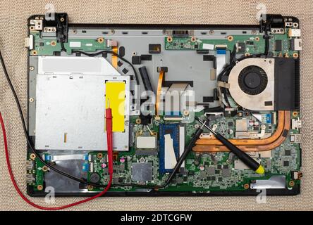 The master removes the cover on the computer with a screwdriver to repair computer equipment Stock Photo