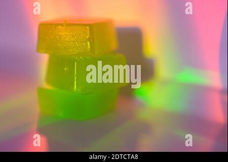 Stack of edible cannabis gummies in rainbow light Stock Photo
