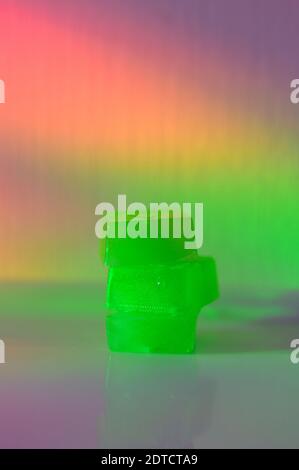 Stack of edible cannabis gummies in rainbow light Stock Photo