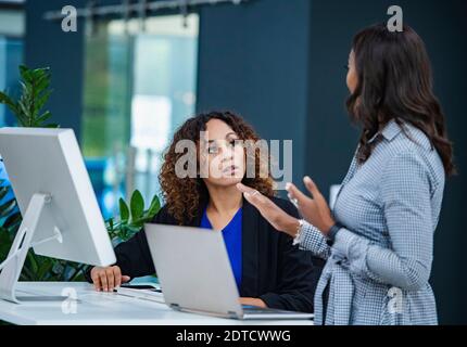 Two women talking in office Stock Photo