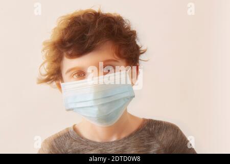 Boy (8-9) wearing protective face mask Stock Photo