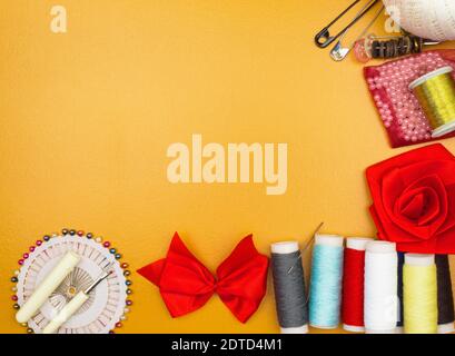 Frame for the background of handmade products. Blank for text and background. Threads and needles, ribbons and braid, multi-colored pins and scissors Stock Photo