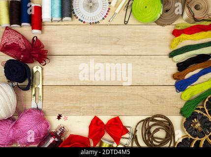 Frame for the background of handmade products. Blank for text and background. Threads and needles, ribbons and braid, multi-colored pins and scissors Stock Photo