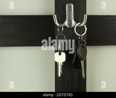 Keys on a hanger in the hallway. Keys on a wooden hanger. Frame for text Stock Photo