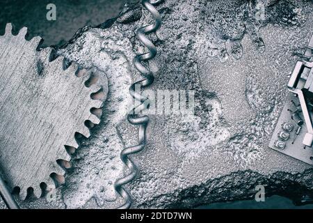 Silver grey grunge gears and wheels create an industrial steampunk background. Stock Photo