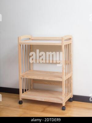 Wooden racks with wheels on wooden floor and white background Stock Photo