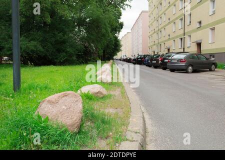 Warsaw, Poland - June 21, 2020: Barrier for cars in the form of stones. Stones on the green zone for protection from cars Stock Photo