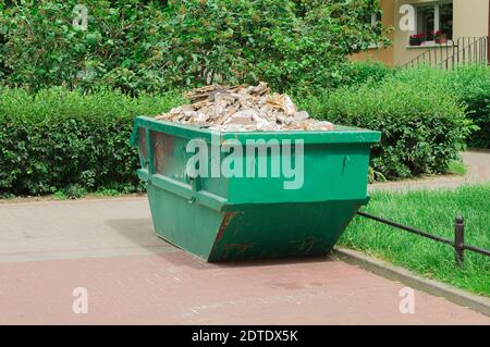 Container with solid household and construction waste. Waste recycling. Caring for the environment Stock Photo