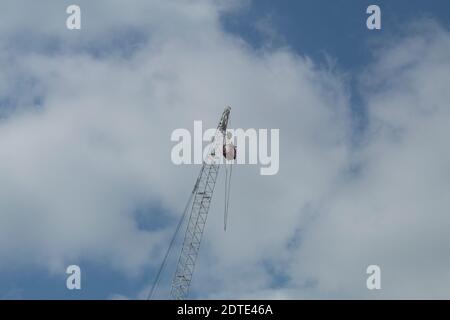 Jump from a height of a tower crane. Jumping from a tower crane. Extreme trick with instructor Stock Photo