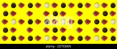 Background pattern strawberries and chocolate. Photo of strawberries and black chocolate and white chocolate evenly laid out on a yellow background Stock Photo