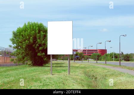 Advertising banner with white space for text on the background of city streets. Against the backdrop of city streets and green lawns Stock Photo
