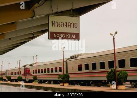 Train By Sign Hanging From Roof At Railroad Station Platform