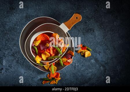 Dry fruit and Healthy vegetable chips, healthy vegan snack, a mixed heap: yellow sweet potato purple sweet potato carrot green radish green beans and Stock Photo