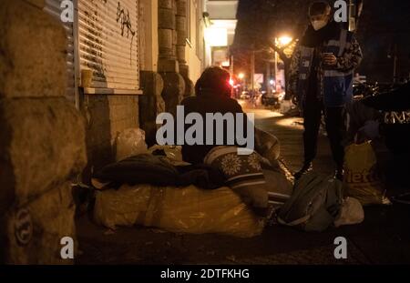 Berlin, Germany. 17th Dec, 2020. Alina (21, r), a volunteer with the Stadtmission's cold weather bus, talks to a homeless man who had set up camp on a sidewalk. Credit: Paul Zinken/dpa/Alamy Live News Stock Photo