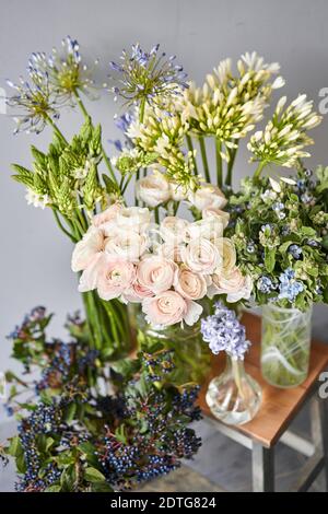 Set of white and blue flowers for Interior decorations. The work of the florist at a flower shop. Fresh cut flower. European floral shop. Delivery Stock Photo
