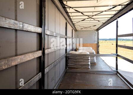 Loading into a tilt trailer of a truck. The process of unloading goods from a large truck Stock Photo