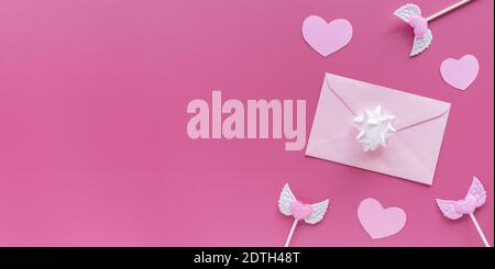 Pink hearts, toppers, envelope with letter on pink background. Valentine's day banner. Stock Photo