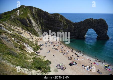 PA REVIEW OF THE YEAR 2020 File photo dated 01/06/20 of people enjoying the warm weather on the beach at Durdle Door, near Lulworth, in Dorset, after the public were reminded to practice social distancing following a relaxation of lockdown restrictions in England. Stock Photo