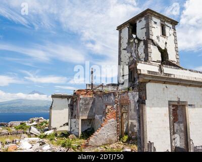 Farol da Ribeirinha, a lighthouse destroyed by an earthquake, island of Pico in the background. Faial Island, an island in the Azores (Ilhas dos Acore Stock Photo