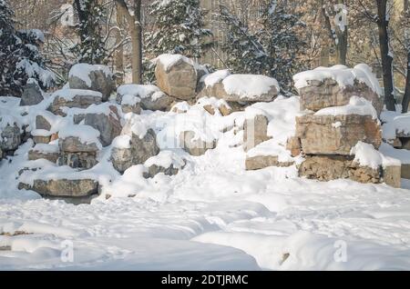 Large stones in winter, covered with snow on a Sunny day Stock Photo