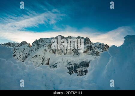 Panoramic view of the north face of Mount Jof di Montasio covered with snow in winter Stock Photo