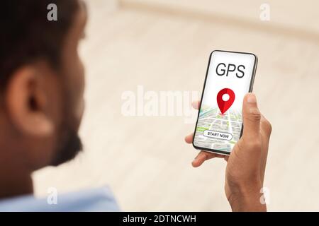 Black Man Browsing Gps App On Smartphone, Tracking Geolocation Stock Photo