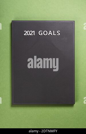 Goal, plan, action text on gray letter board. 2021 New year on green paper ultimate background Stock Photo