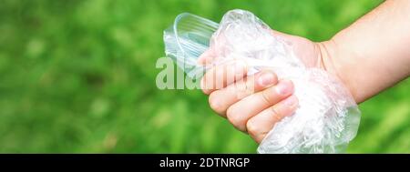 The person holds used crumpled plastic debris in his hand. Environmental problem concept. Stock Photo