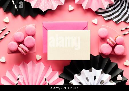 Card with copy-space and envelope. Happy Birthday Sweet and tasty macaroons and coffee. Creative monochrome flat lay on pink color paper. Folded paper Stock Photo