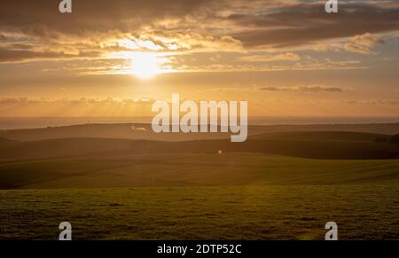 Sunset viewed from the South Downs at Firle Beacon, East Sussex, UK Stock Photo