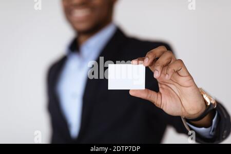 Empty card in african american man hands, selective focus Stock Photo