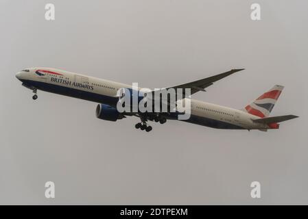 Departures are continuing from London Heathrow Airport as countries ban travel from UK, taking off into very low overcast weather. BA 777 to Mumbai Stock Photo